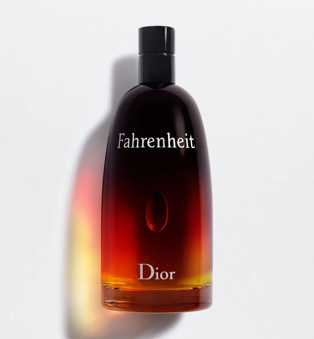 Dior Fahrenheit perfume bottle with amber gradient liquid and black cap, luxury men's fragrance