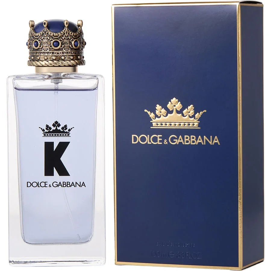 Dolce & Gabbana 'K' Eau de Toilette bottle with a crown on the cap, next to its blue box packaging with the Dolce & Gabbana logo.