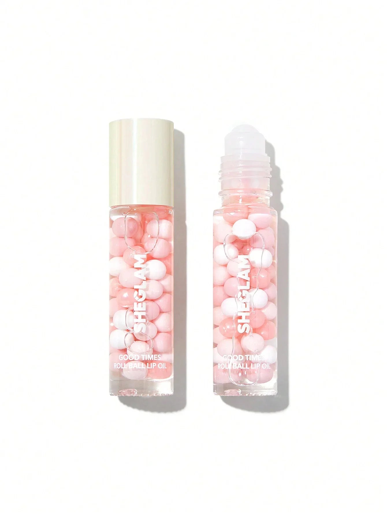 Sheglam Good Times roll ball lip oil with pink and white beads, clear bottle, beauty cosmetic product