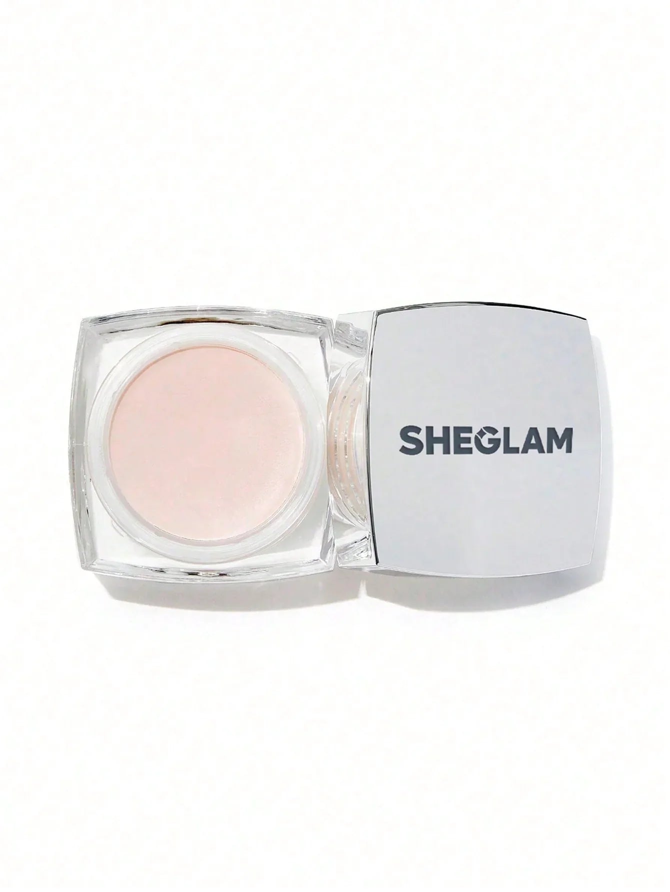 SHEGLAM highlighter in clear compact with soft pink shimmer, perfect for glowy makeup looks