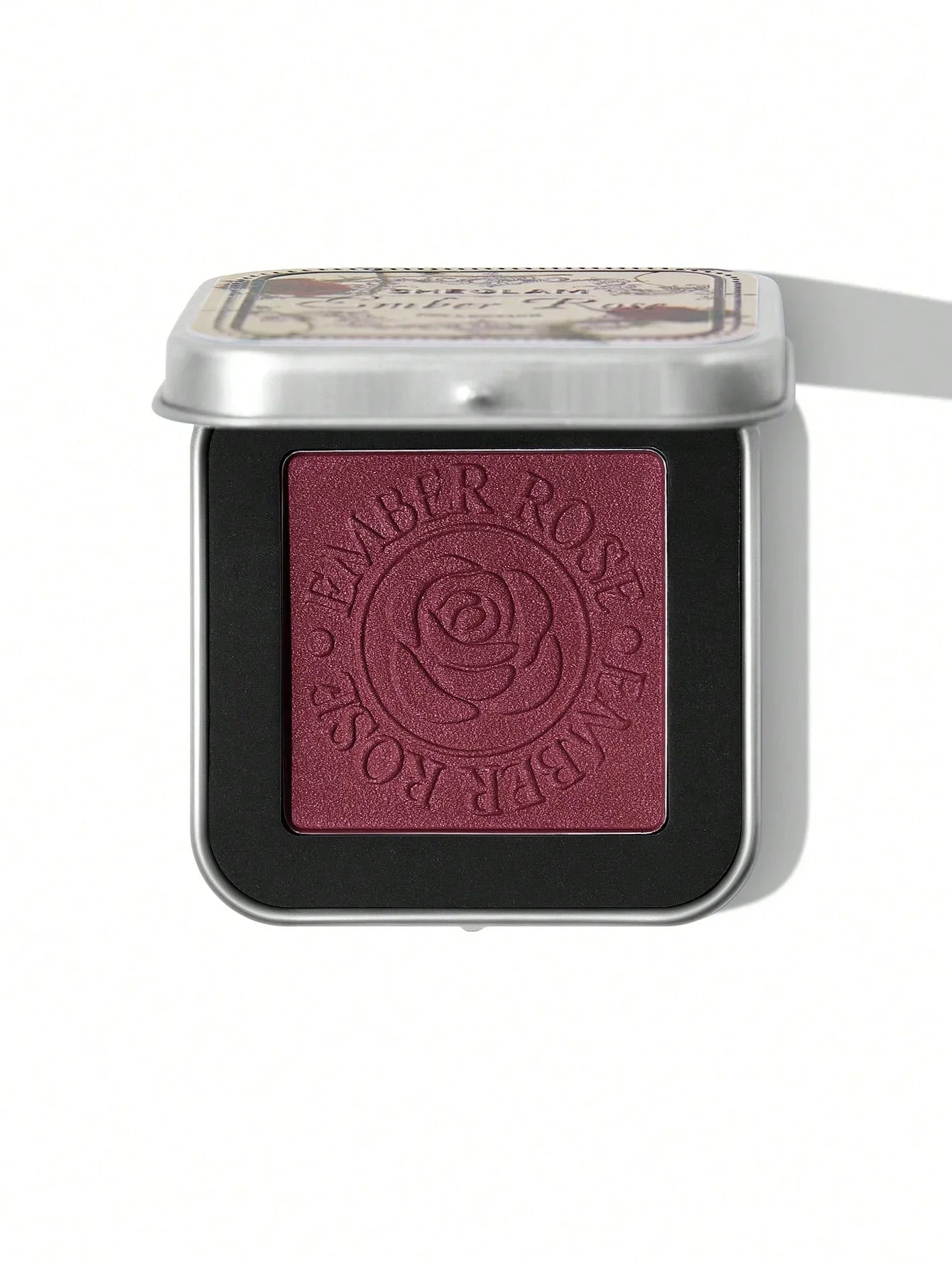 Ember Rose eyeshadow in rich burgundy with rose embossing, perfect for bold makeup looks.