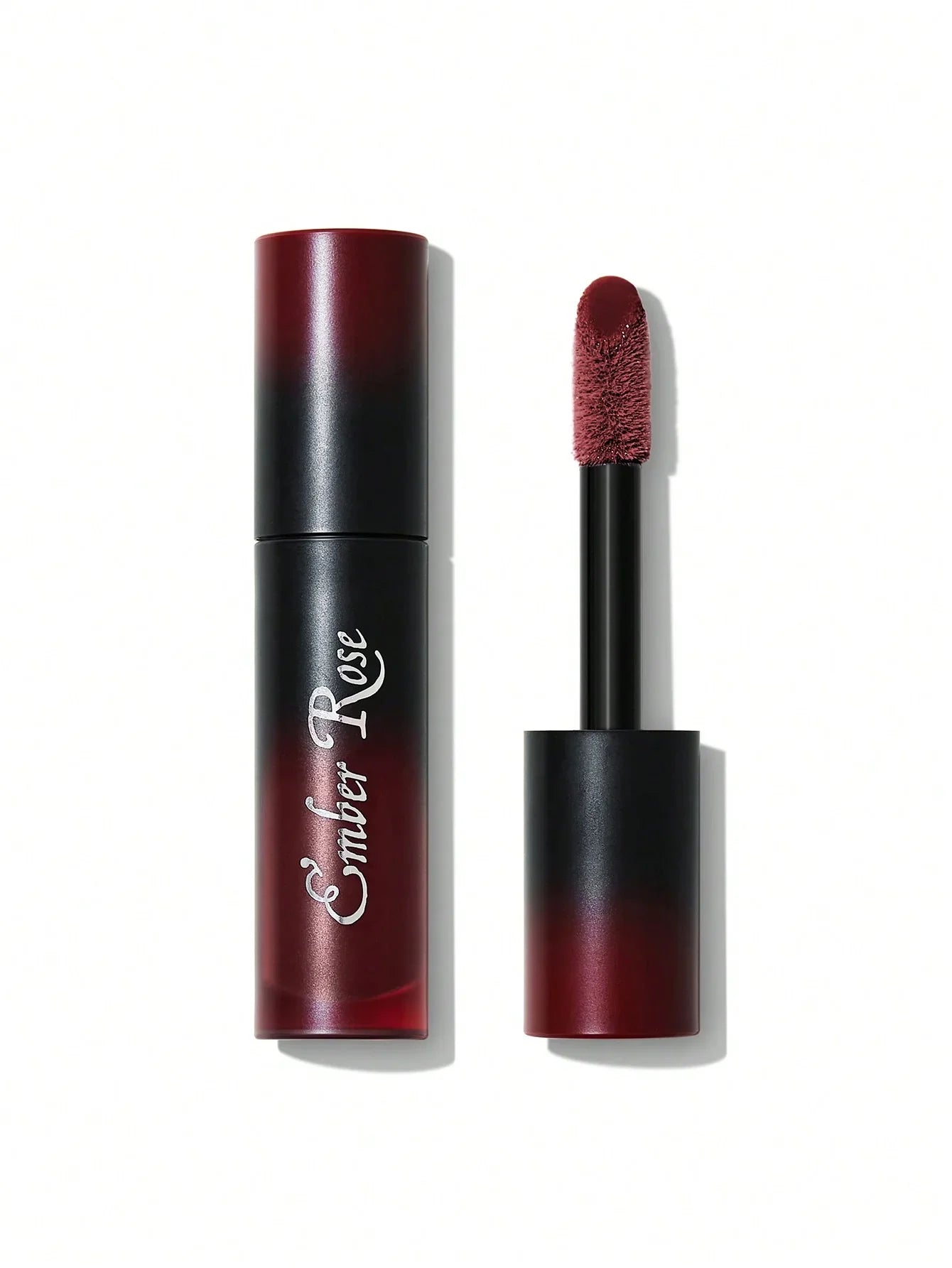 Ember Rose matte liquid lipstick in deep red shade, sleek black tube with applicator shown