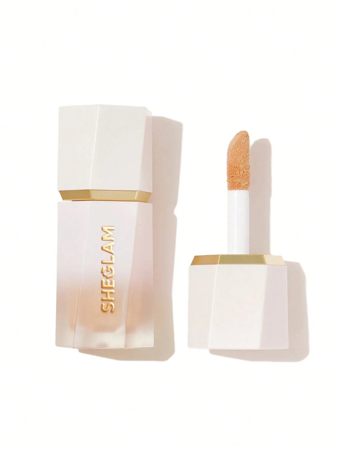 SHEGLAM liquid concealer with gold accents, creamy beige formula, sleek white packaging for flawless coverage