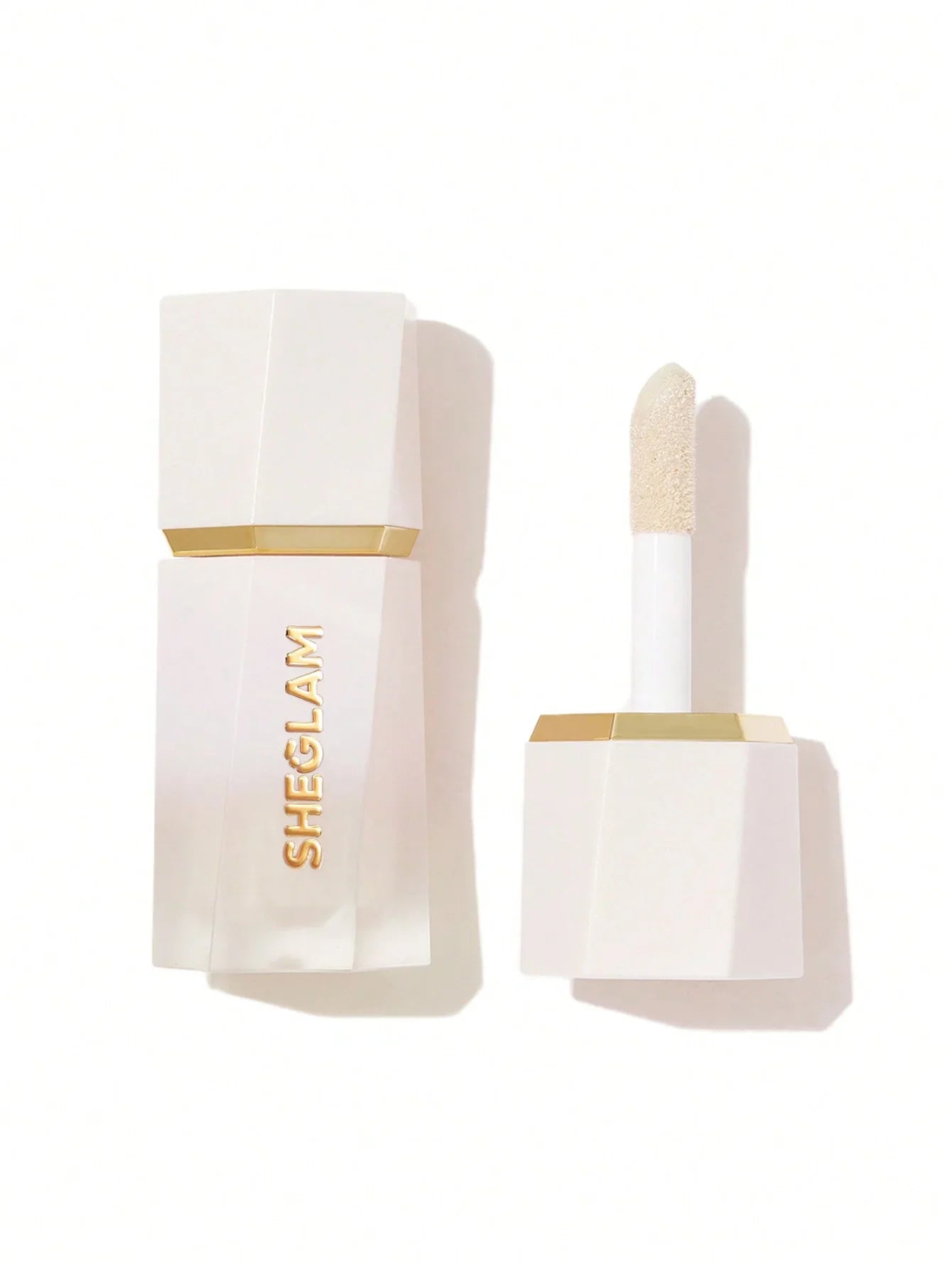 Sheglam shimmer lip gloss with gold accents, sleek white packaging, and applicator wand