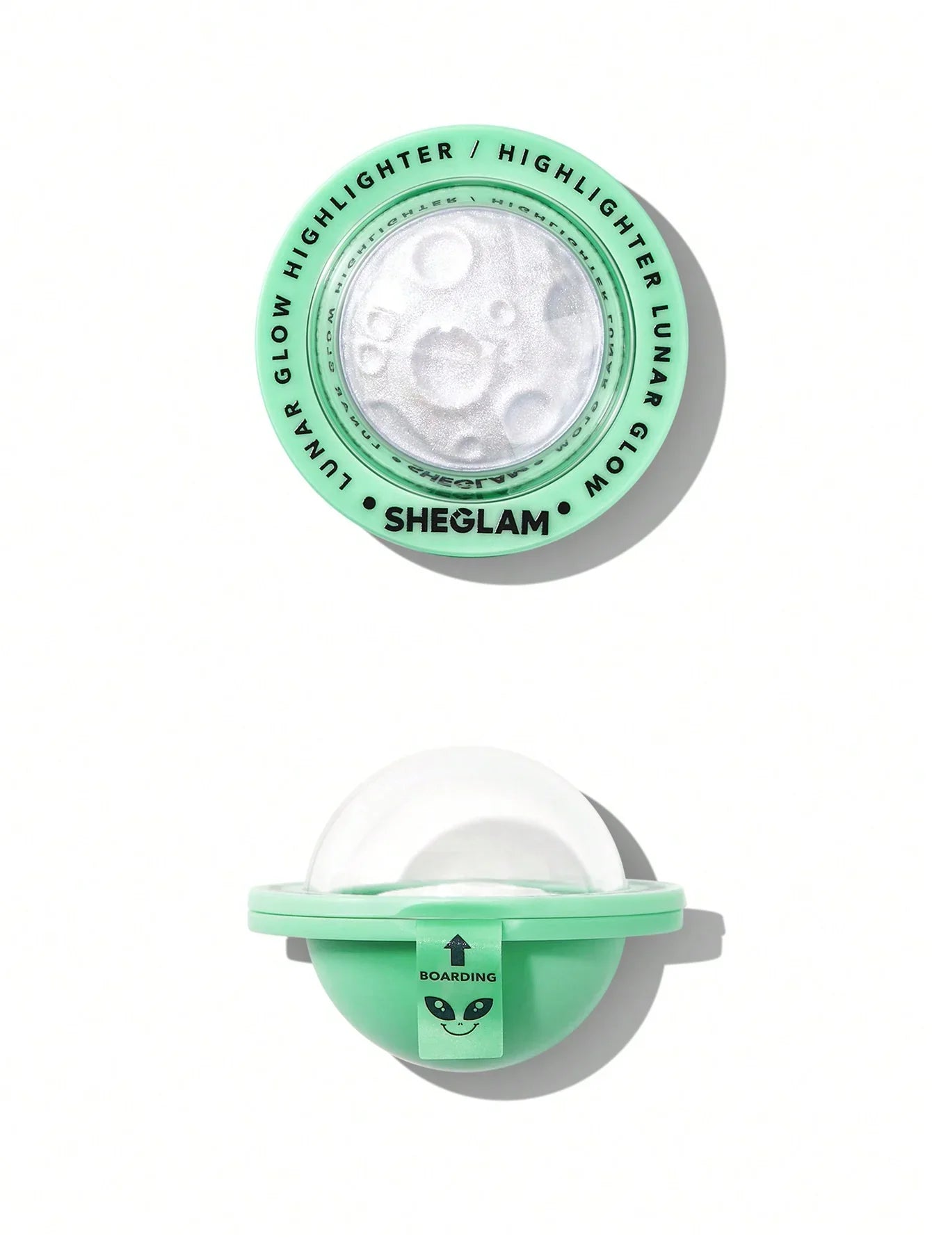 Sheglam Lunar Glow Highlighter in mint green packaging with alien design, featuring shimmering white powder and 'Boarding' tag.