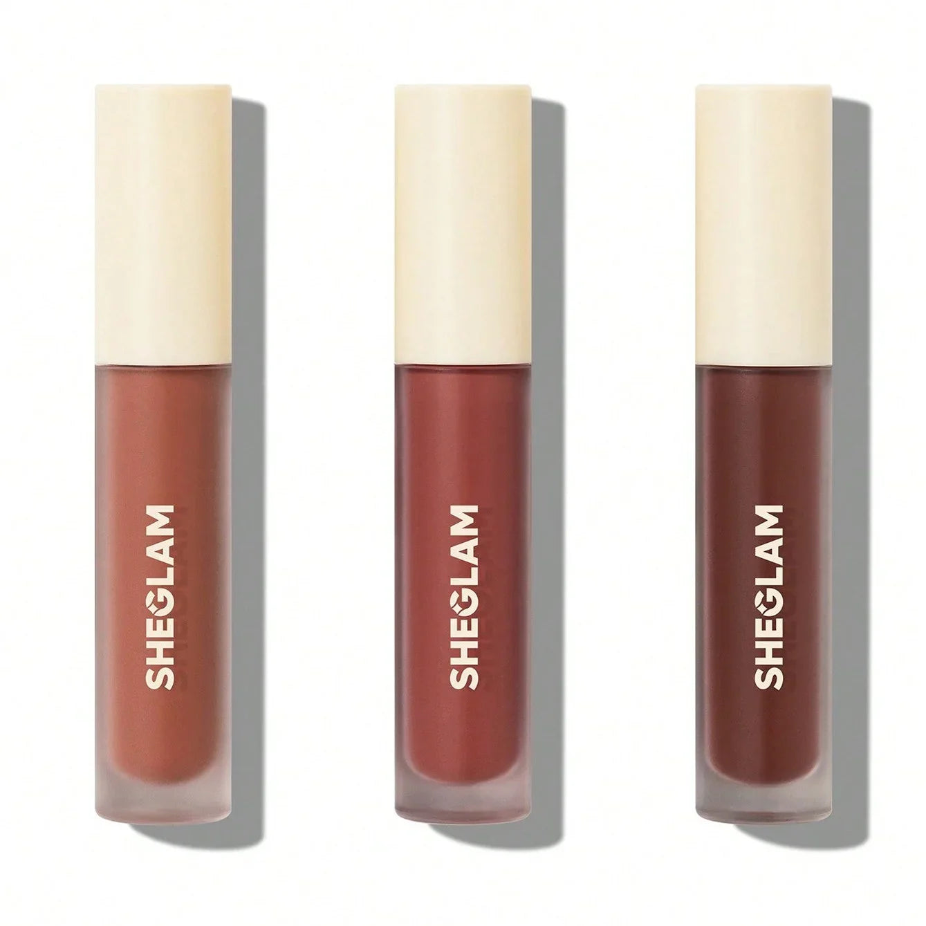 Three Sheglam liquid lipsticks in warm matte shades, perfect for everyday wear and bold looks.
